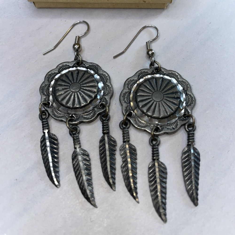 Southwestern style dangling pewter concho earrings with dangling feathers
